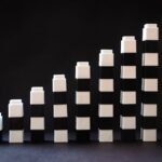 Black and white toy blocks arranged in ascending order to symbolize growth or progress.